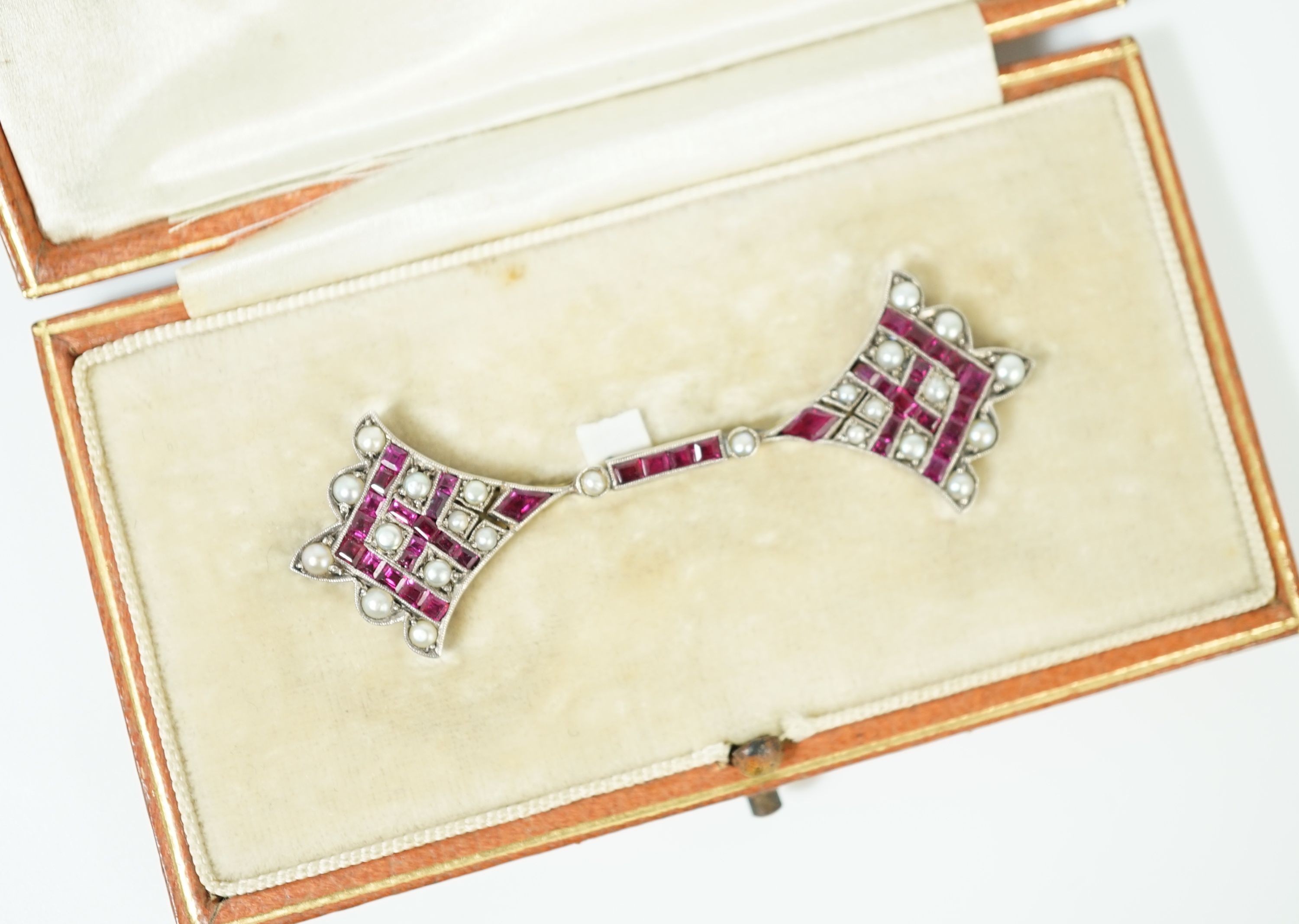 An early 20th century, gold, platinum, ruby and seed pearl set brooch